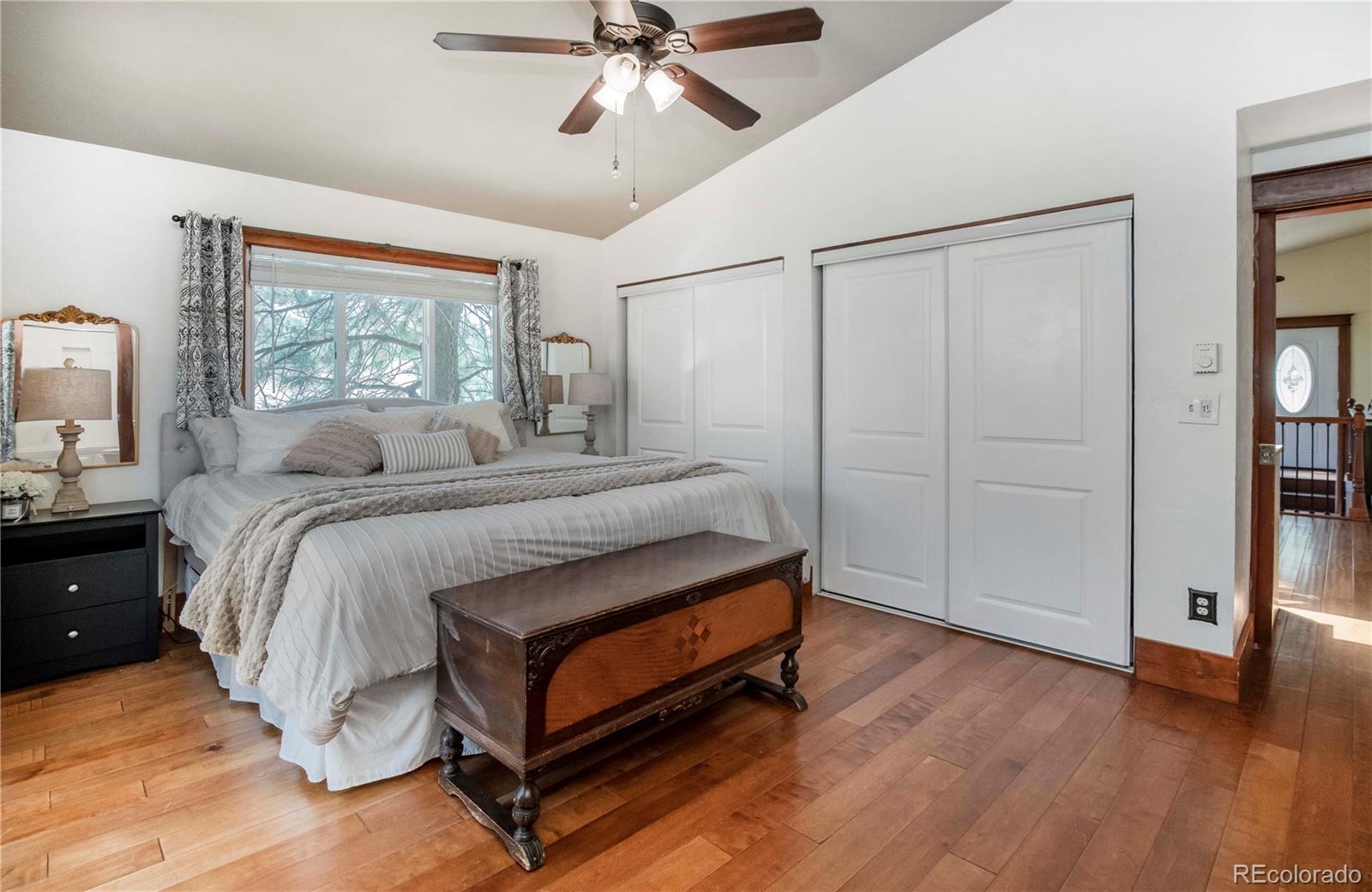 4805 Blue Spruce Road Evergreen, CO 80439 - Photo 16 of 43 a bedroom with a bed and a painting on the wall