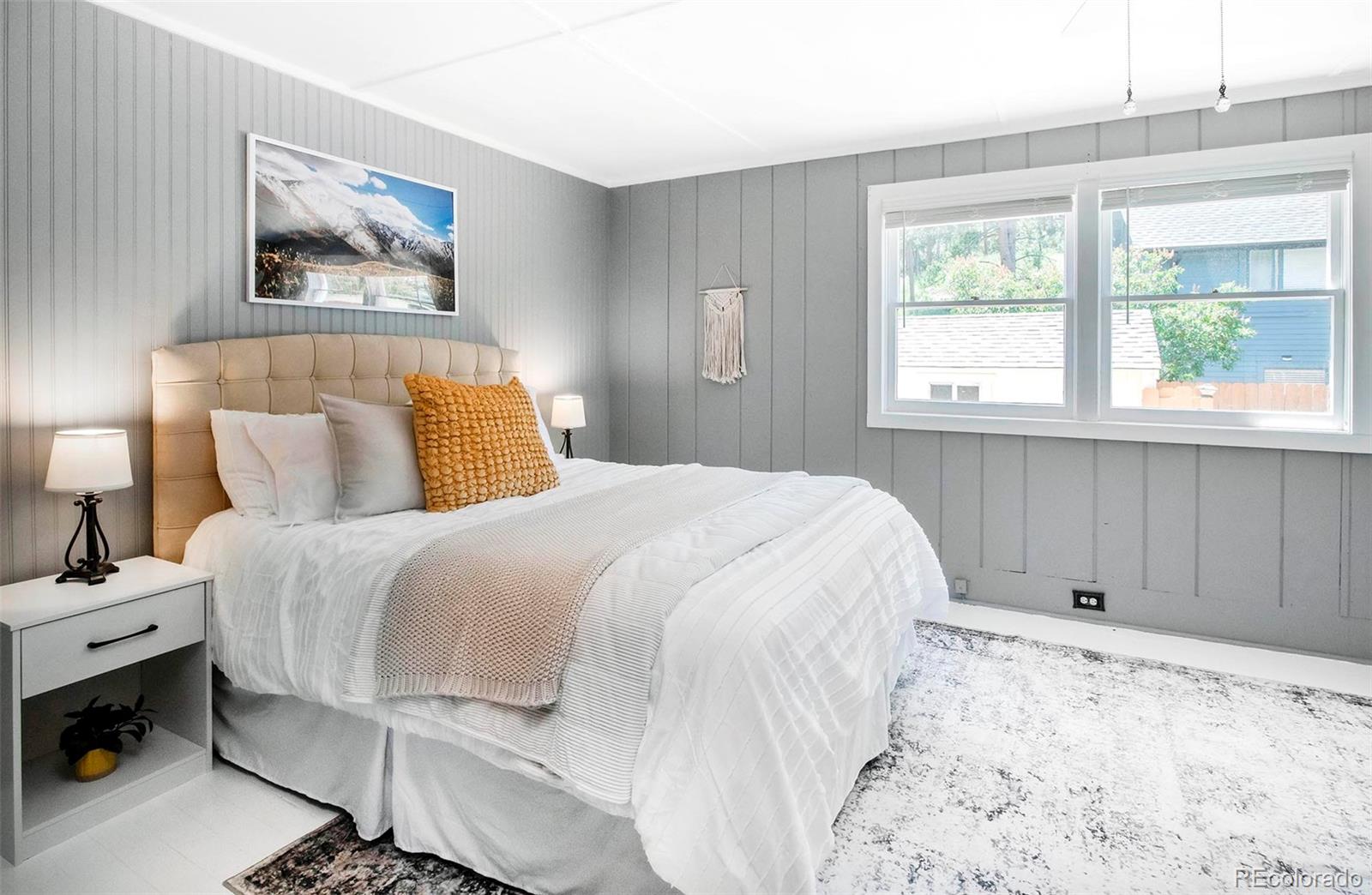 4805 Blue Spruce Road Evergreen, CO 80439 - Photo 23 of 43 a bedroom with a bed and a window