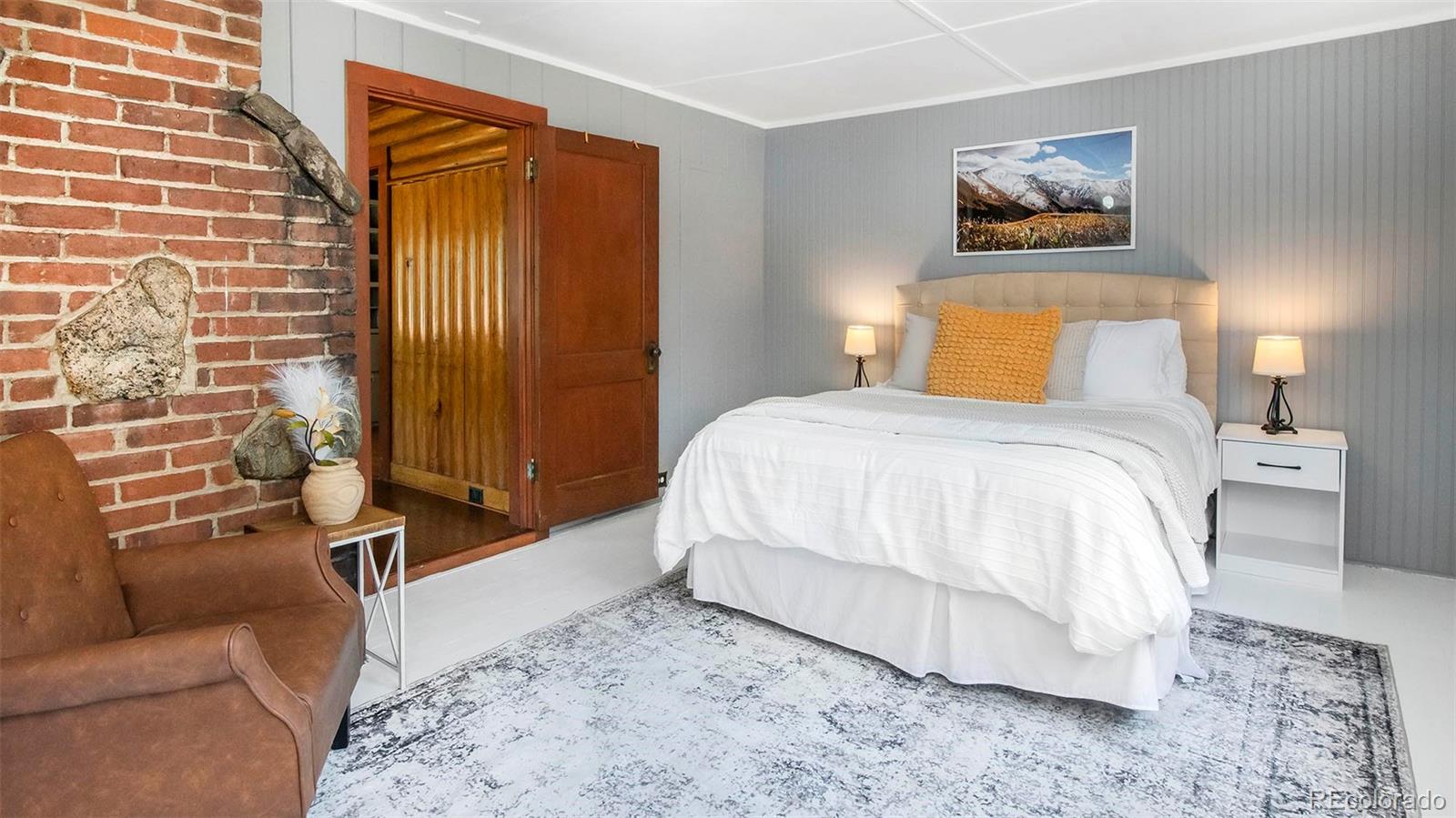 4805 Blue Spruce Road Evergreen, CO 80439 - Photo 24 of 43 a bedroom with a bed and a couch