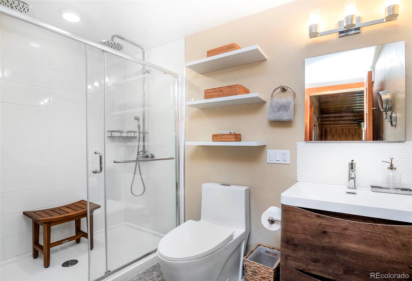 4805 Blue Spruce Road Evergreen, CO 80439 - Photo 26 of 43 a bathroom with a sink toilet and shower