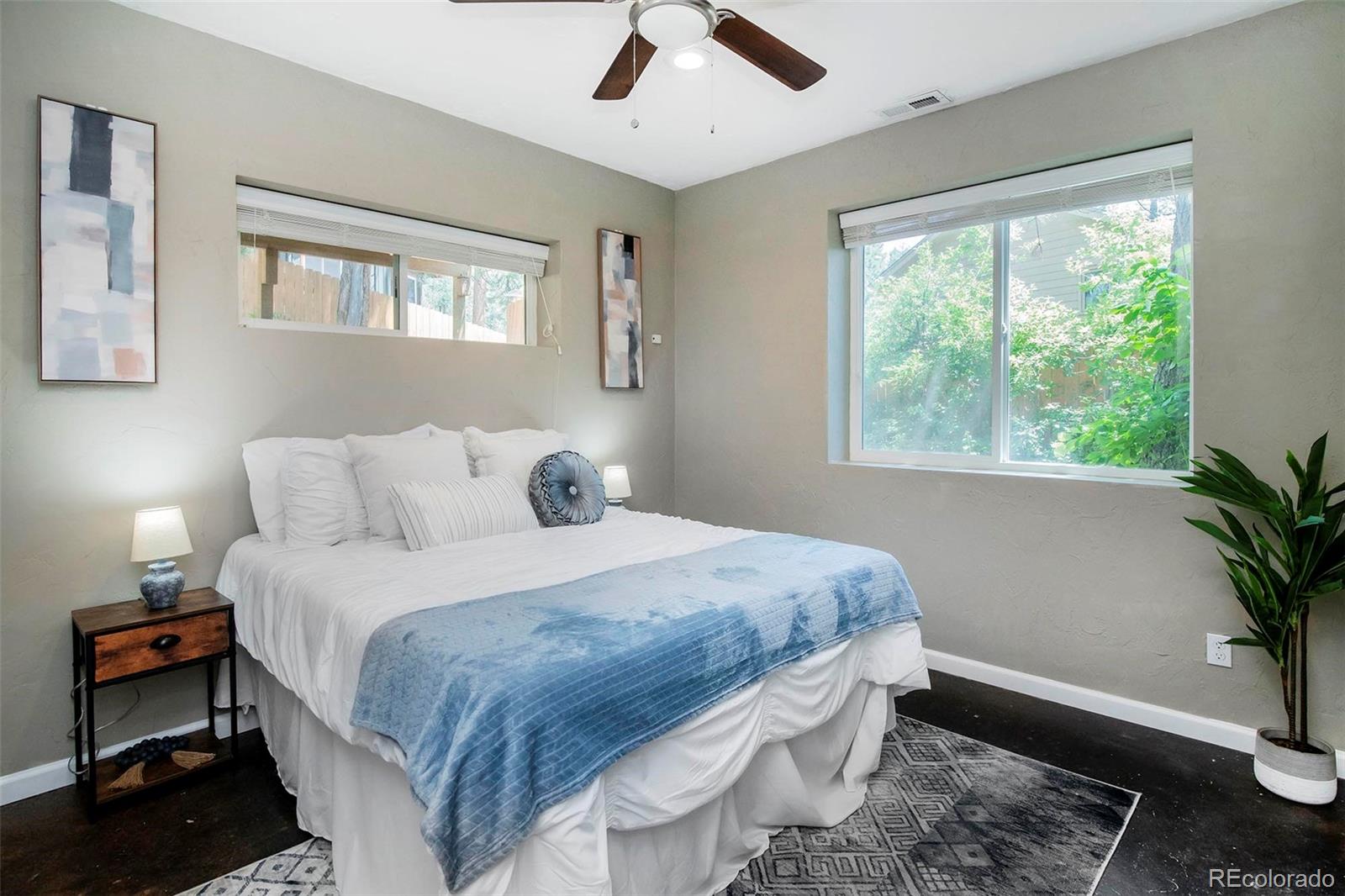 4805 Blue Spruce Road Evergreen, CO 80439 - Photo 29 of 43 a spacious bedroom with a bed and a window