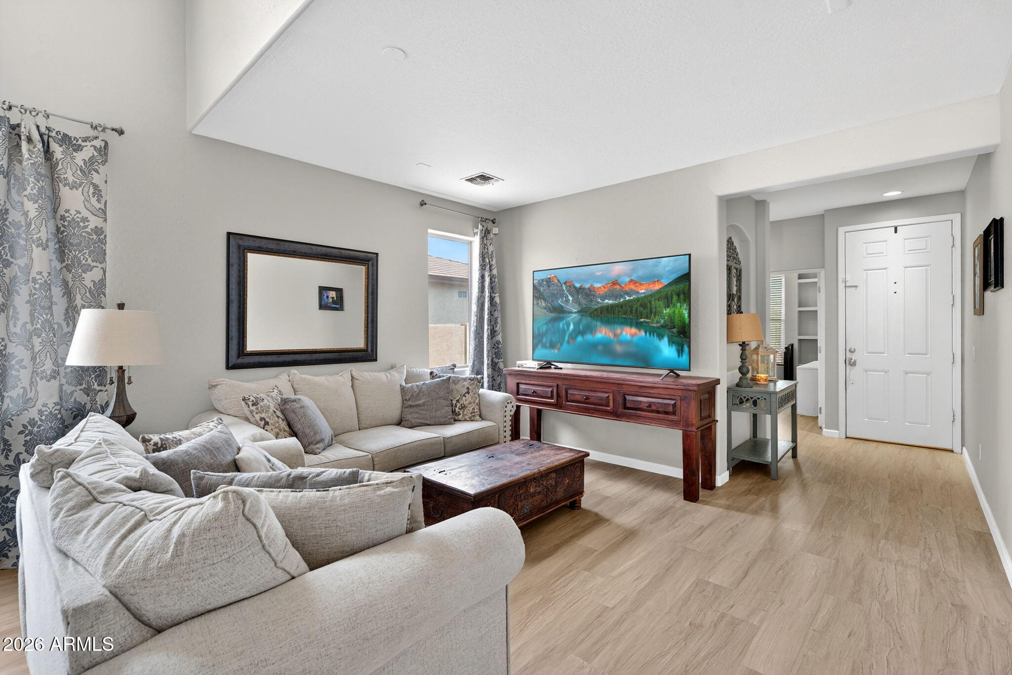 6280 South Sinova Court Gilbert, AZ 85298 - Photo 5 of 64 a living room with furniture and a flat screen tv