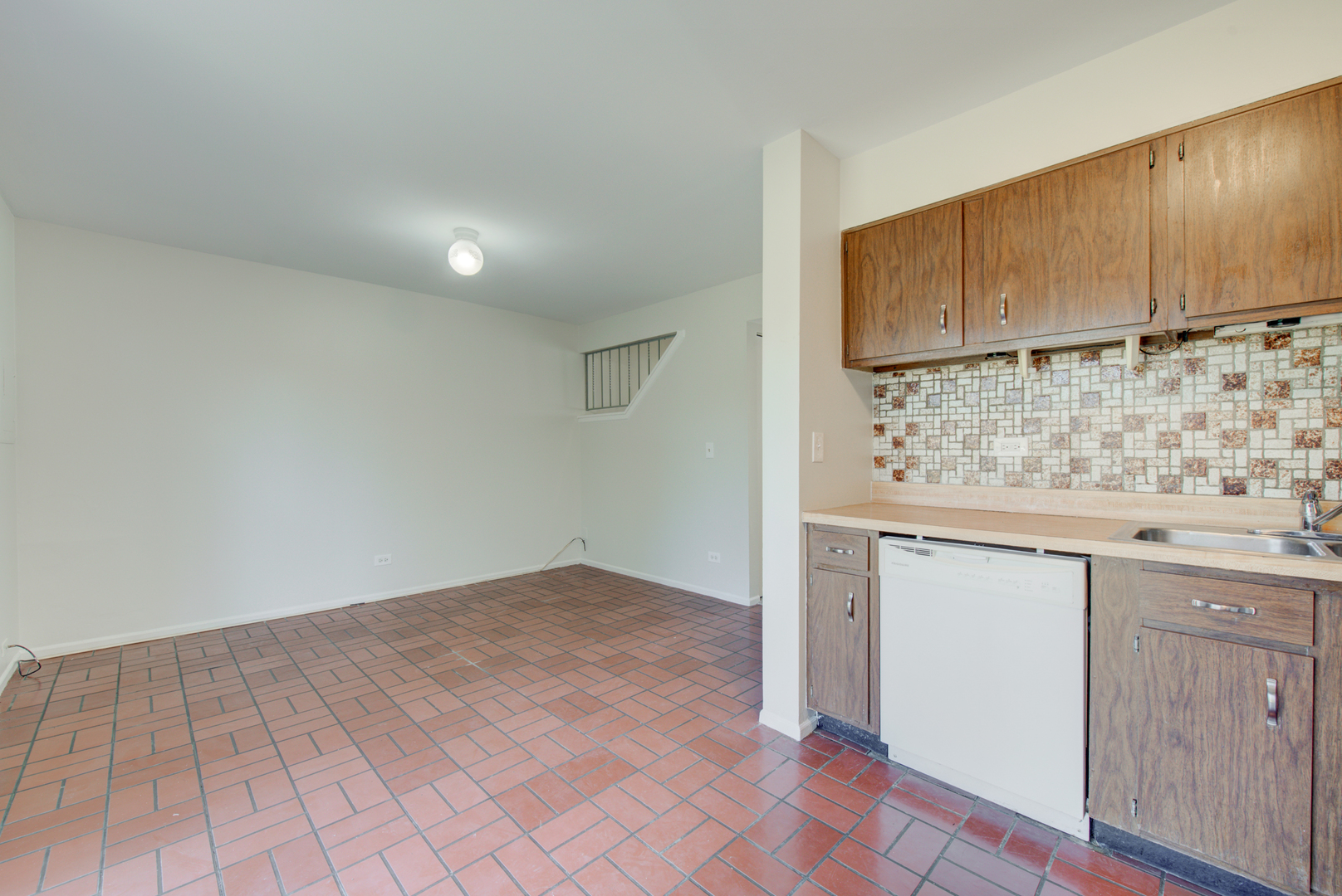 354 Rodenburg Road Roselle, IL 60172 - Photo 8 of 26 an empty room with wooden floor and cabinet