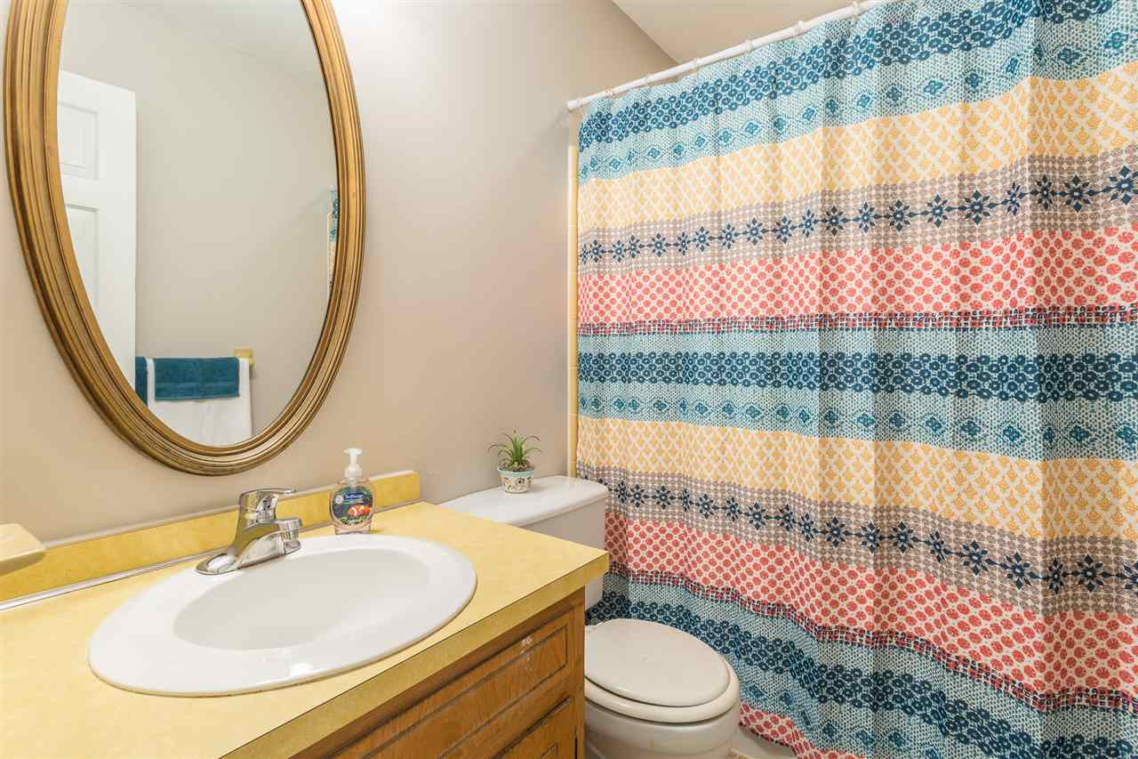 8816 Woodstone Drive Raleigh, NC 27615 - Photo 22 of 30 The hall bath on the second floor has title flooring and tile shower. Linen closet is located across the hall from this bathroom. 2nd Floor Hall Bath