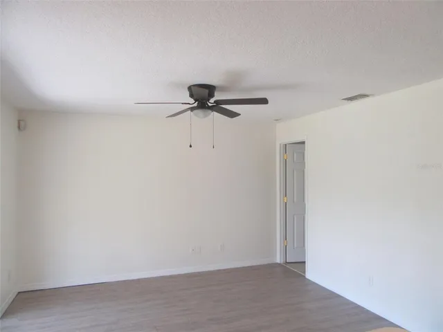 a view of a room with a ceiling fan