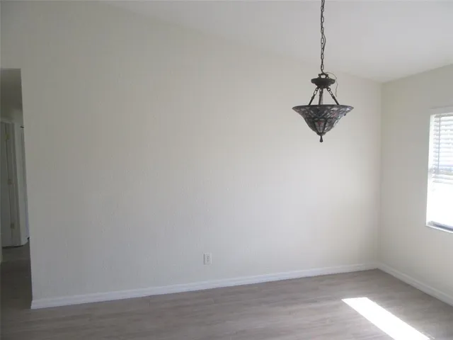 a view of a room with a window and a ceiling fan