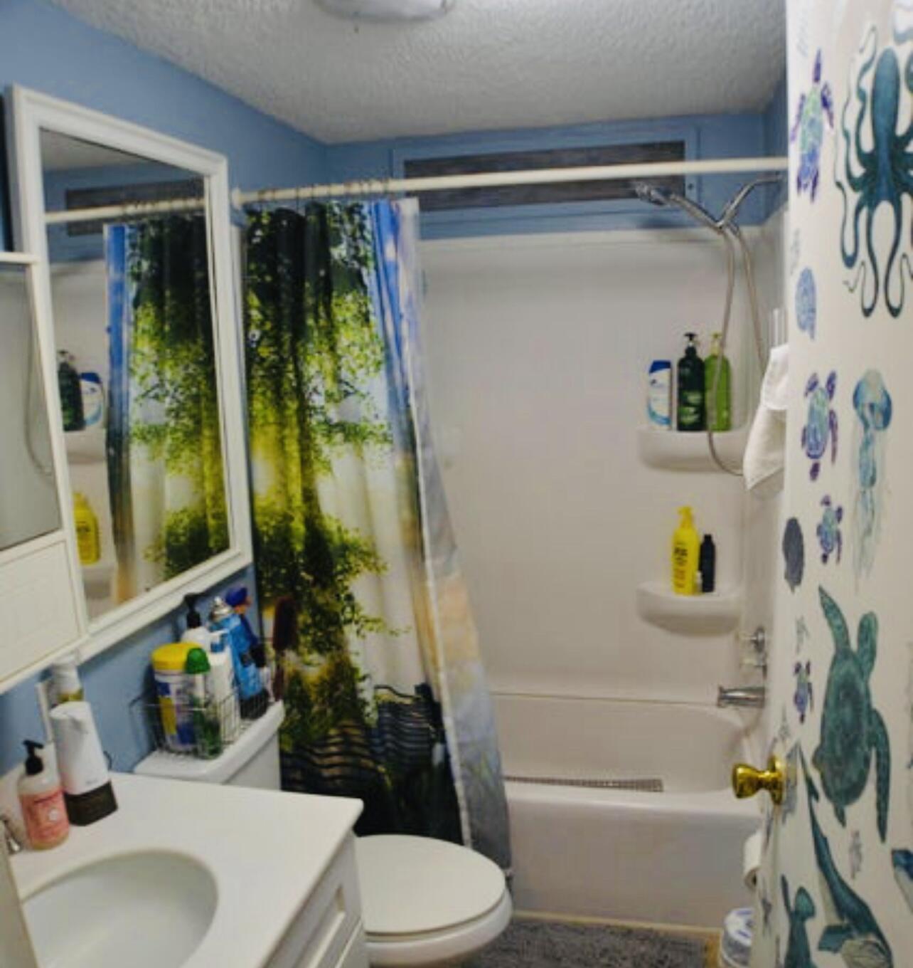 6554 Highway 441 Okeechobee, FL 34974 - Photo 22 of 22 a bathroom with a sink toilet and shower