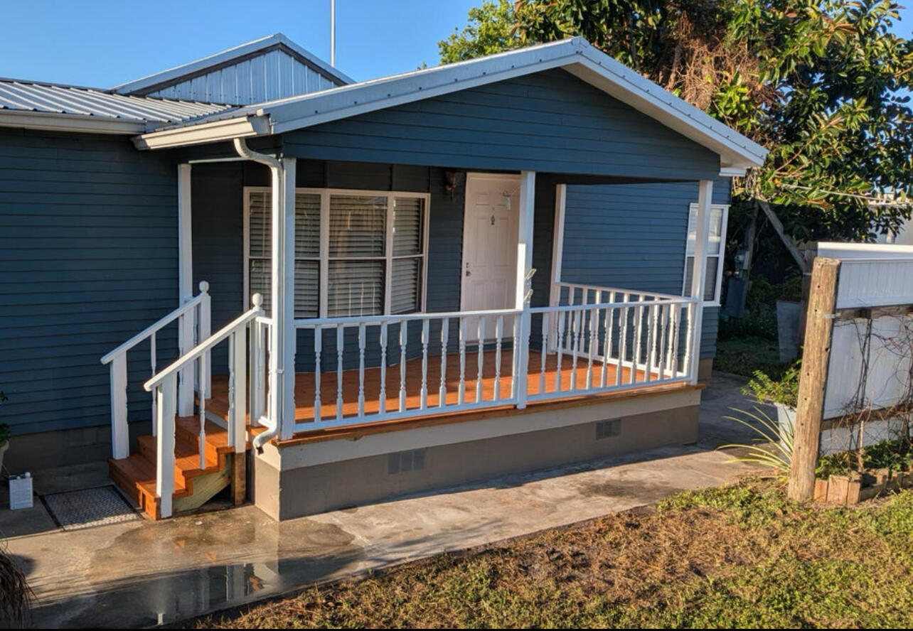 6554 Highway 441 Okeechobee, FL 34974 - Photo 4 of 22 a view of a house with wooden deck and a floor to ceiling window