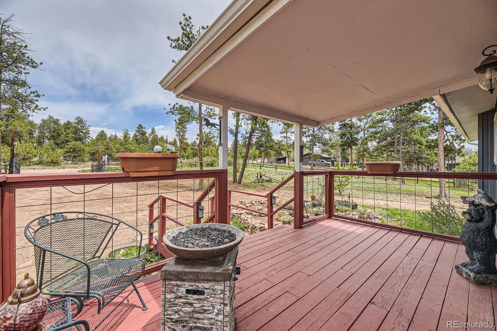 34886 Mohawk Trail Pine, CO 80470 - Photo 20 of 34 a view of a chairs and table on the wooden deck