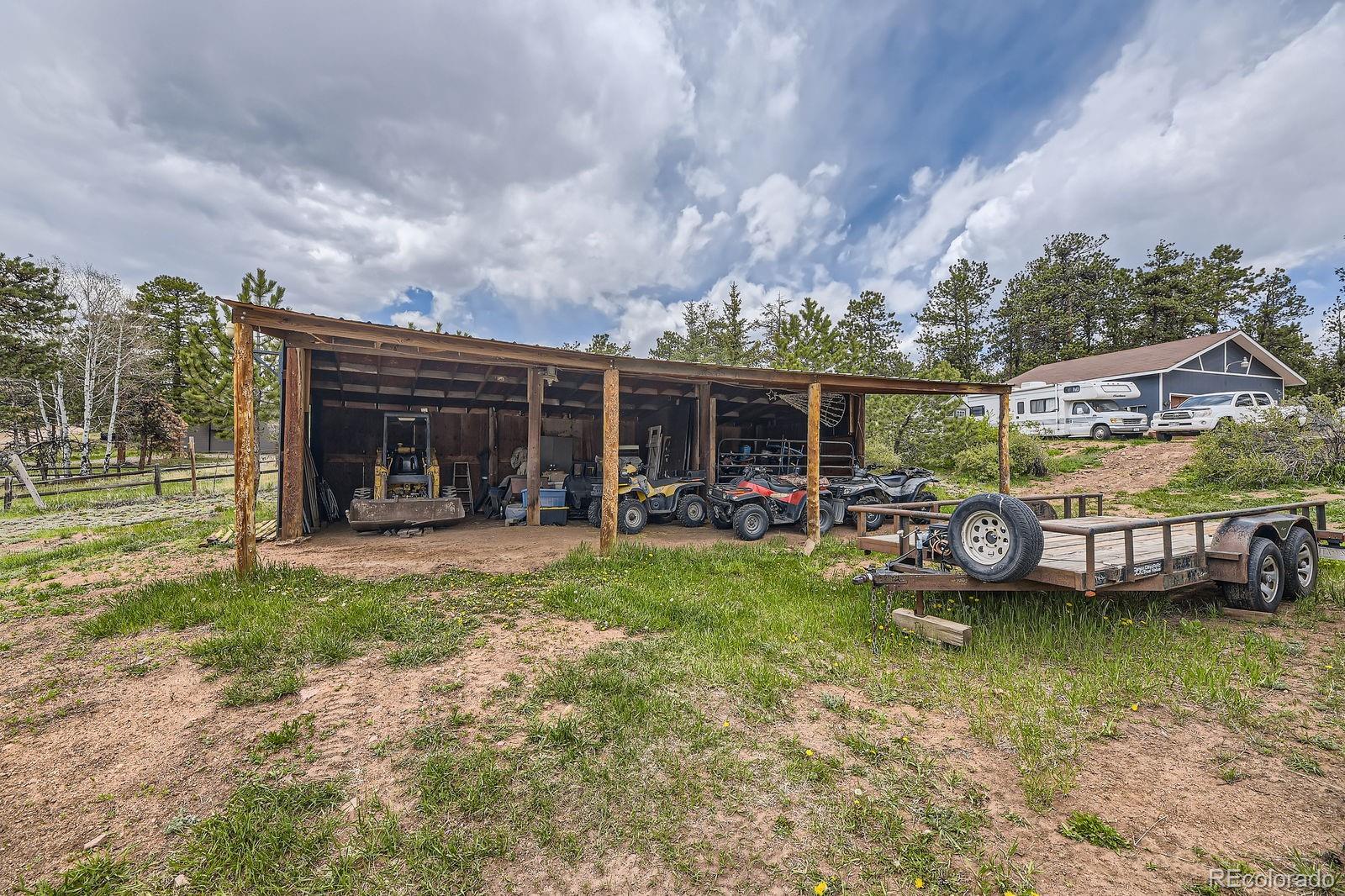 34886 Mohawk Trail Pine, CO 80470 - Photo 21 of 34 a view of a house with backyard porch and furniture