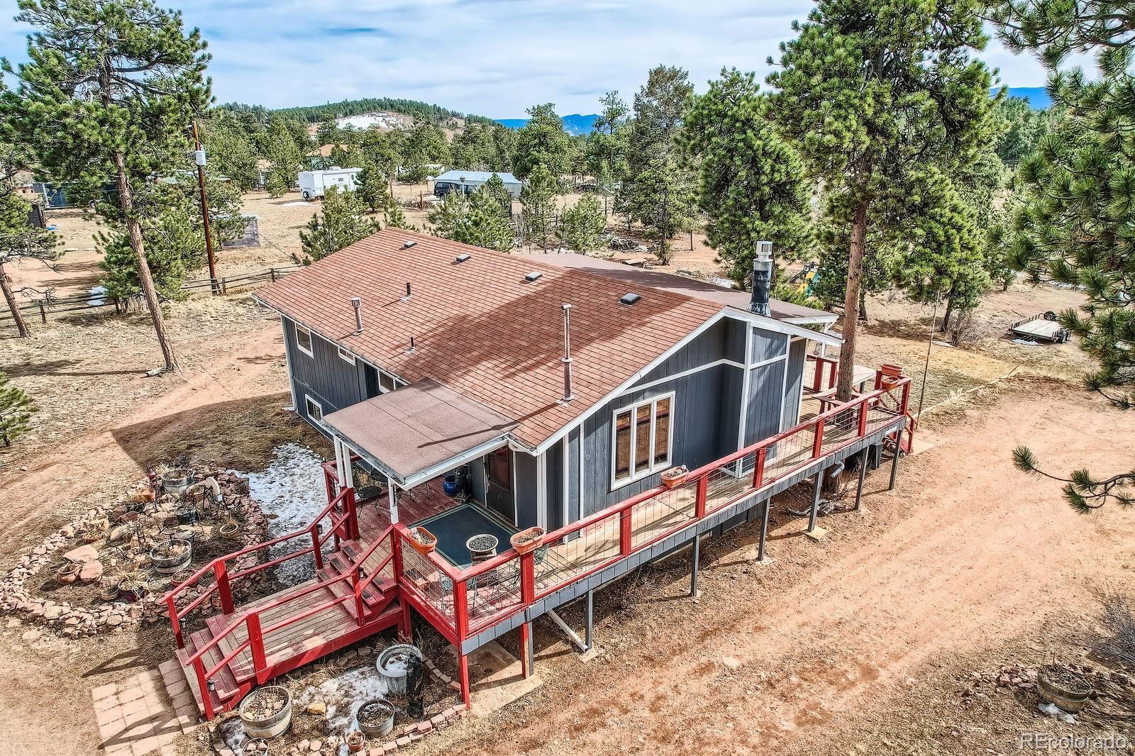34886 Mohawk Trail Pine, CO 80470 - Photo 25 of 34 an aerial view of a house with roof deck