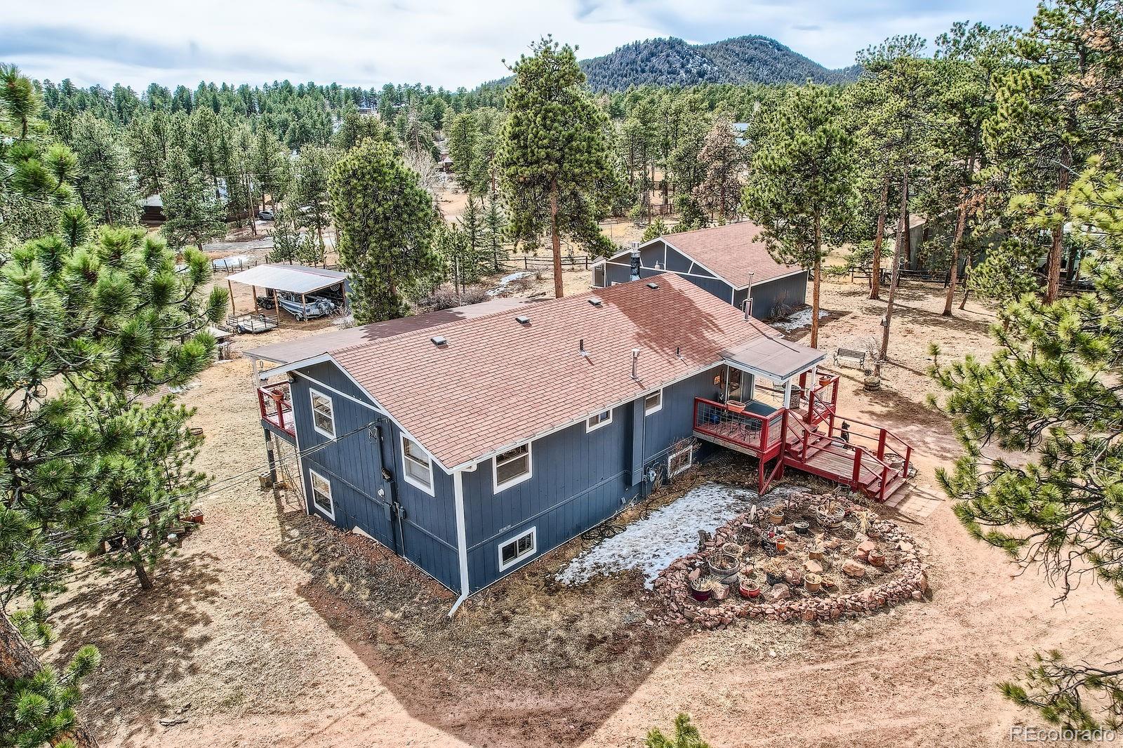 34886 Mohawk Trail Pine, CO 80470 - Photo 26 of 34 a view of an house with backyard space and balcony