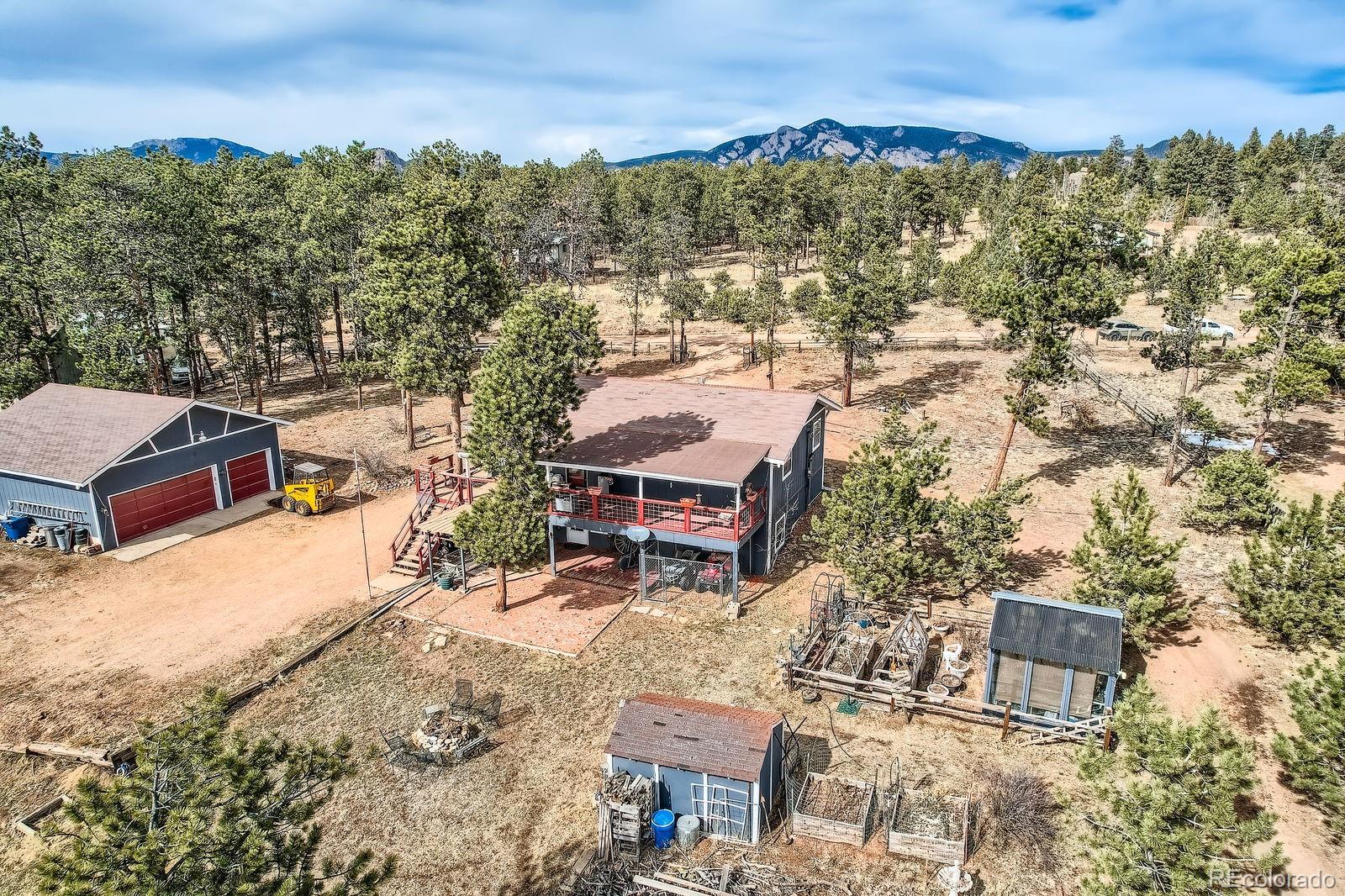 34886 Mohawk Trail Pine, CO 80470 - Photo 27 of 34 an aerial view of a house with a yard and mountain view in back