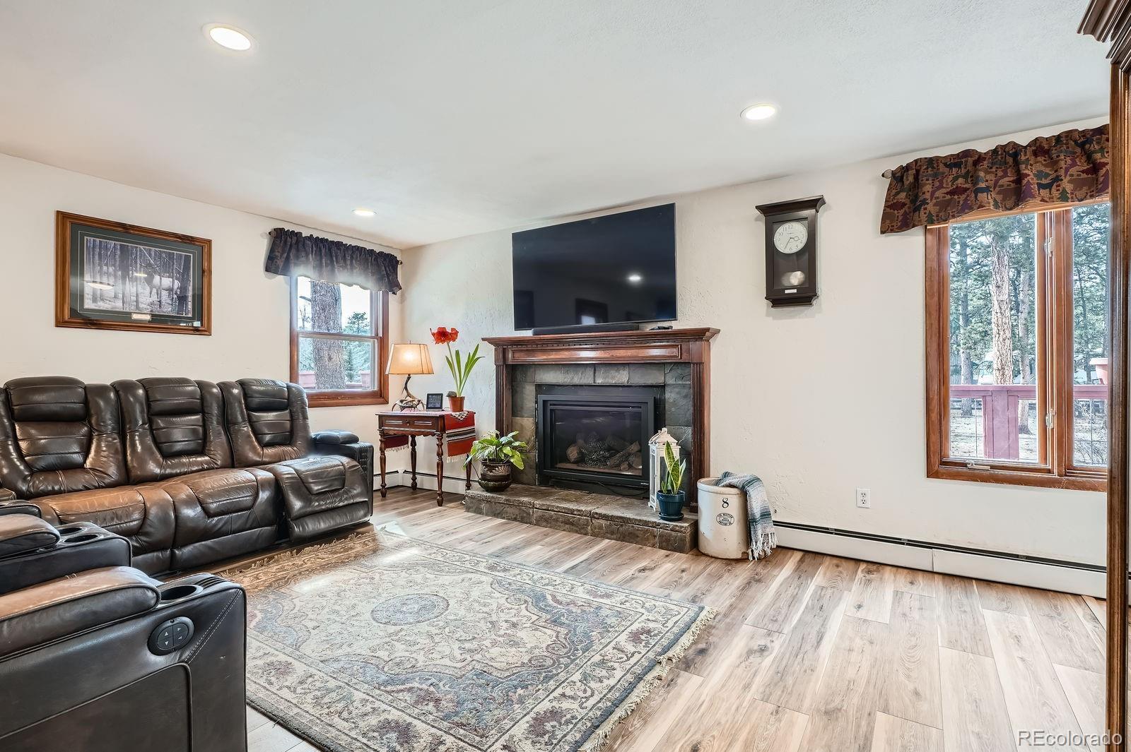 34886 Mohawk Trail Pine, CO 80470 - Photo 4 of 34 a living room with furniture and a fireplace
