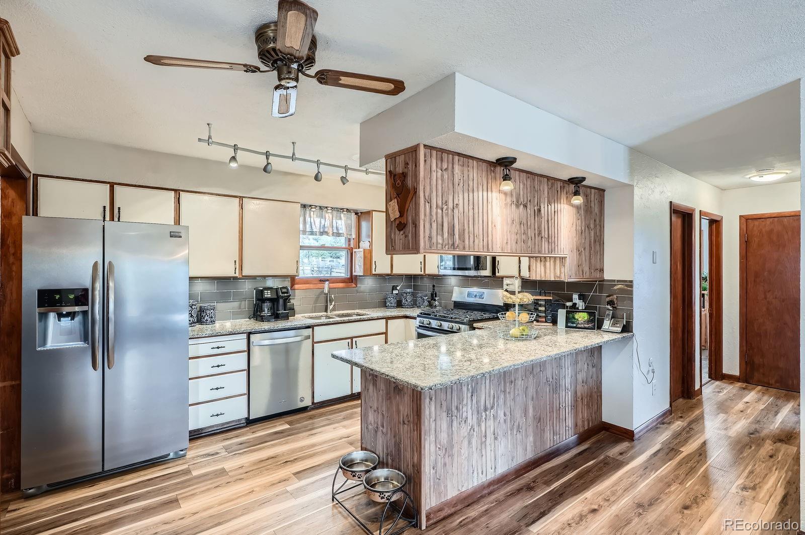 34886 Mohawk Trail Pine, CO 80470 - Photo 5 of 34 a kitchen with kitchen island a large counter top space appliances and cabinets