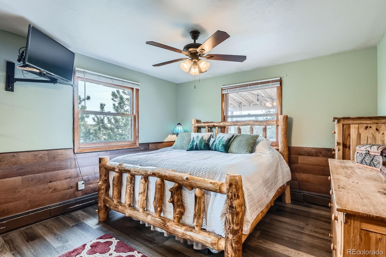 34886 Mohawk Trail Pine, CO 80470 - Photo 6 of 34 a bedroom with a bed and a chandelier