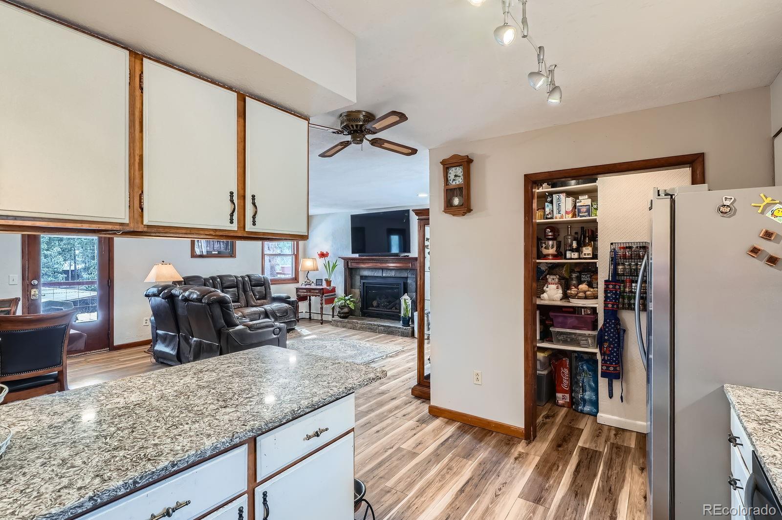 34886 Mohawk Trail Pine, CO 80470 - Photo 9 of 34 a kitchen with sink refrigerator and cabinets