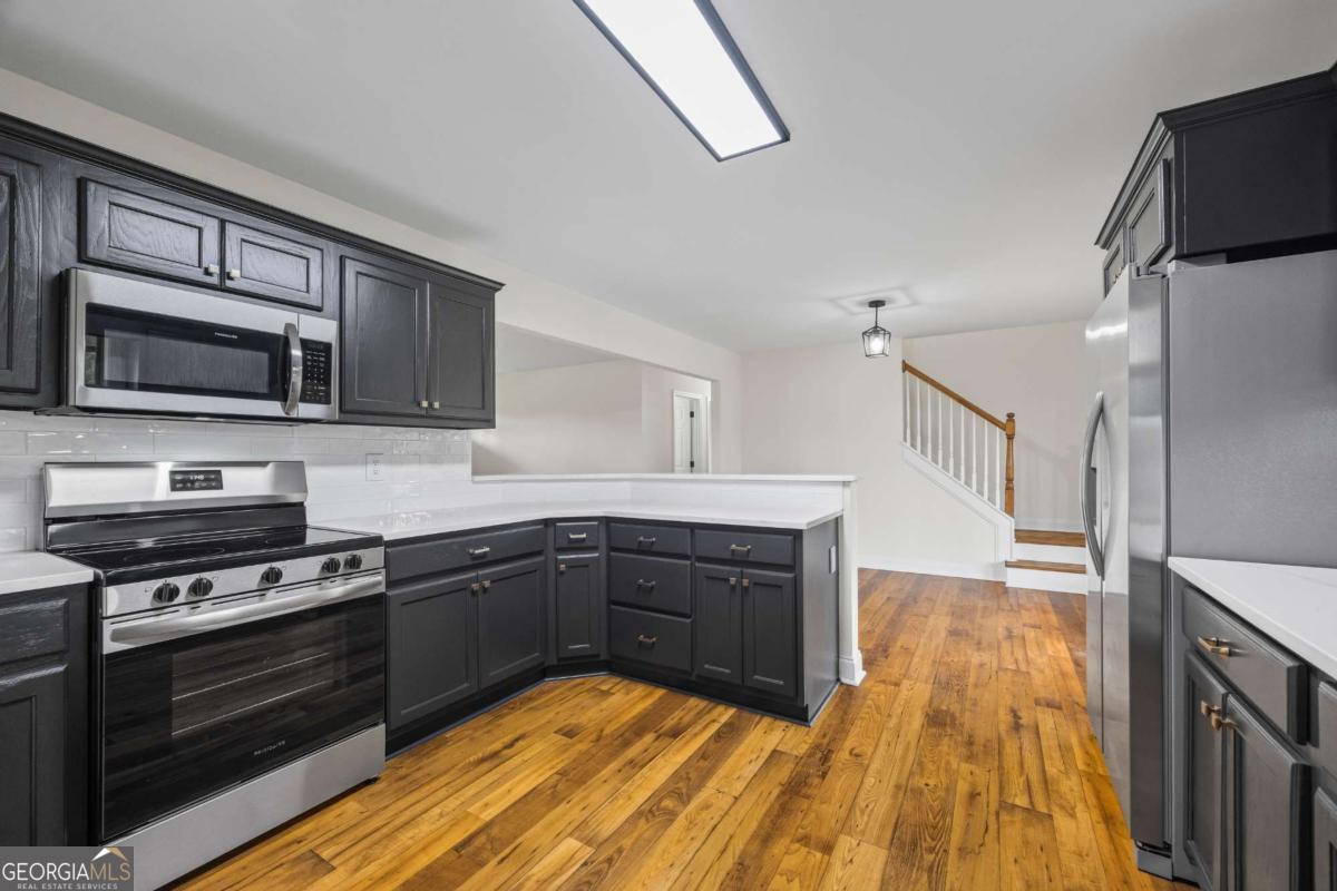 0 Ed Bennett Road Nicholson, GA 30565 - Photo 30 of 71 a kitchen with wooden floors and stainless steel appliances