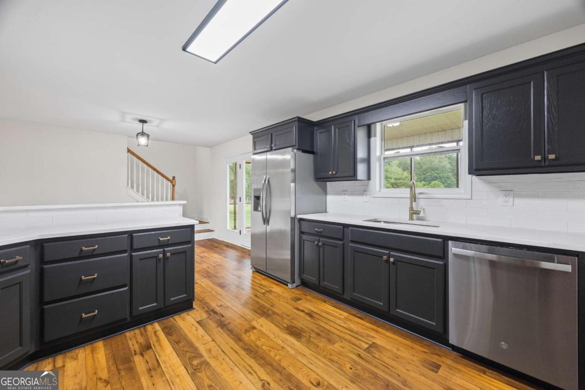 0 Ed Bennett Road Nicholson, GA 30565 - Photo 31 of 70 a kitchen with stainless steel appliances granite countertop a sink dishwasher stove and refrigerator