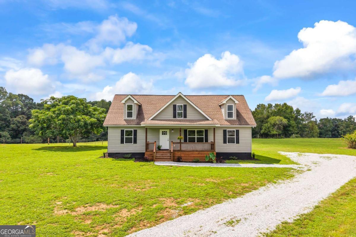 0 Ed Bennett Road Nicholson, GA 30565 - Photo 9 of 70 a front view of a house with garden and swimming pool
