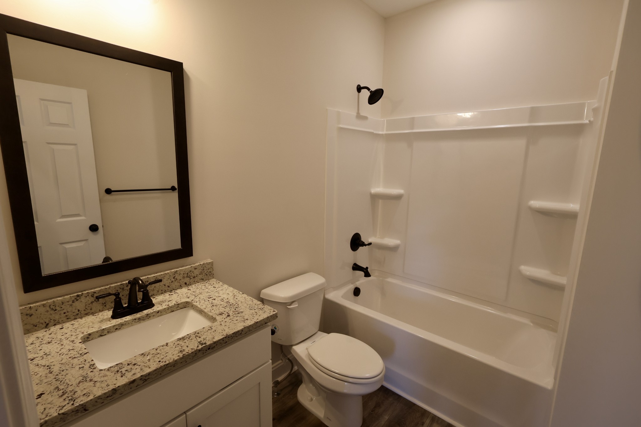 500 Peachers Mill Road, Unit B4 Clarksville, TN 37042 - Photo 17 of 26 a bathroom with a granite countertop sink toilet mirror vanity and bathtub