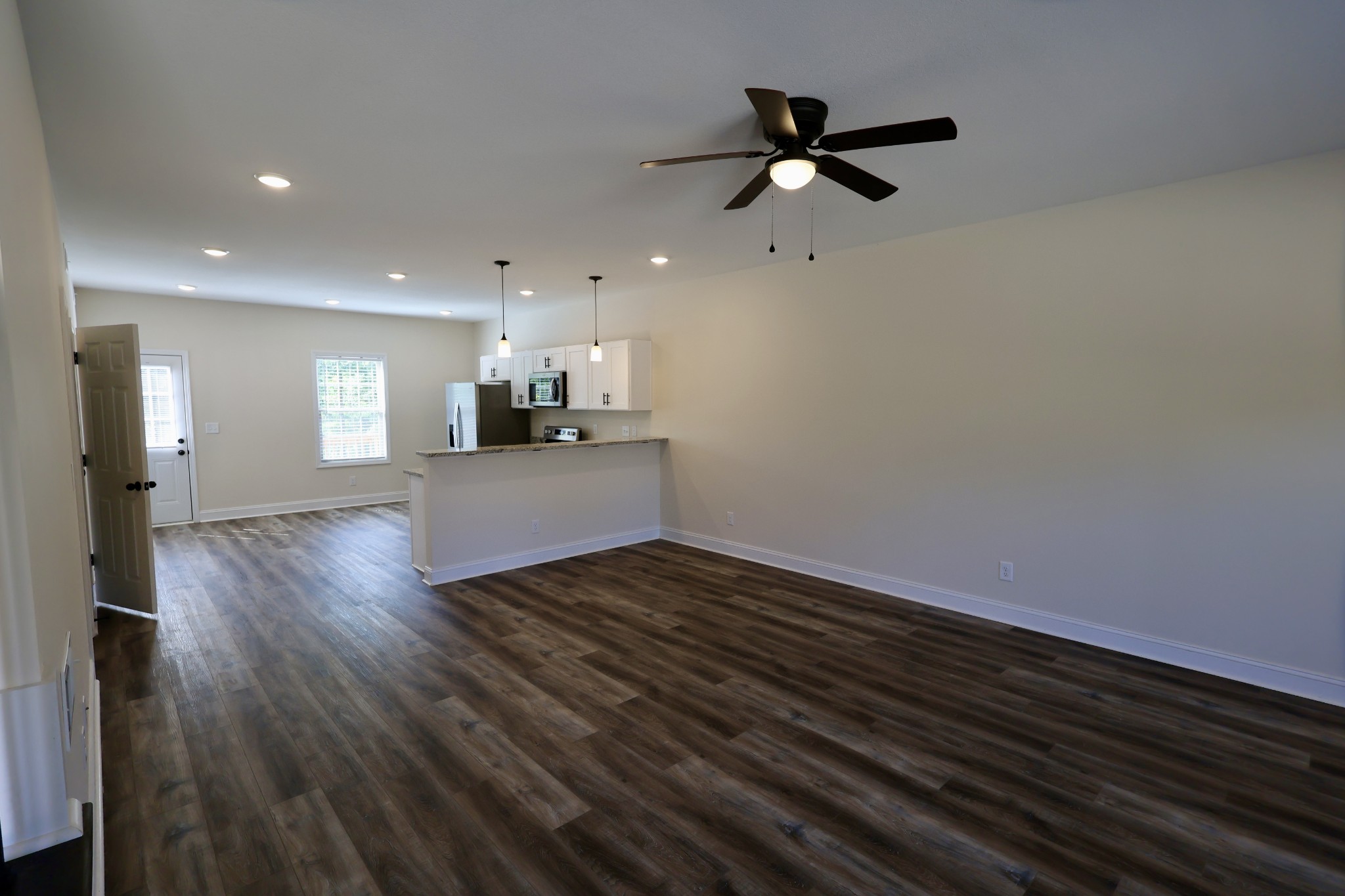 500 Peachers Mill Road, Unit B4 Clarksville, TN 37042 - Photo 3 of 26 a view of a livingroom with a ceiling fan wooden floor and a ceiling fan