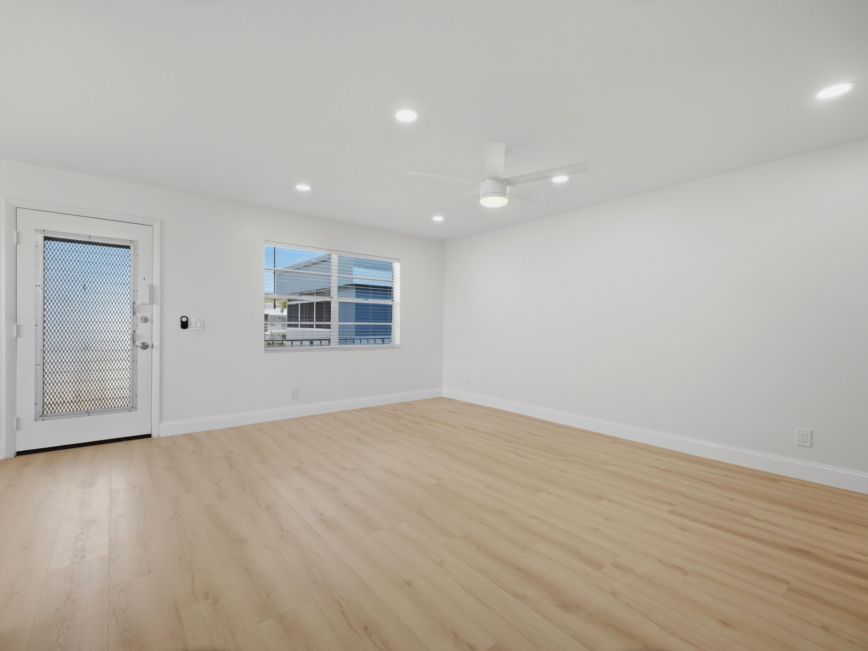 699 Flanders O Delray Beach, FL 33484 - Photo 13 of 39 a view of empty room with wooden floor and fan