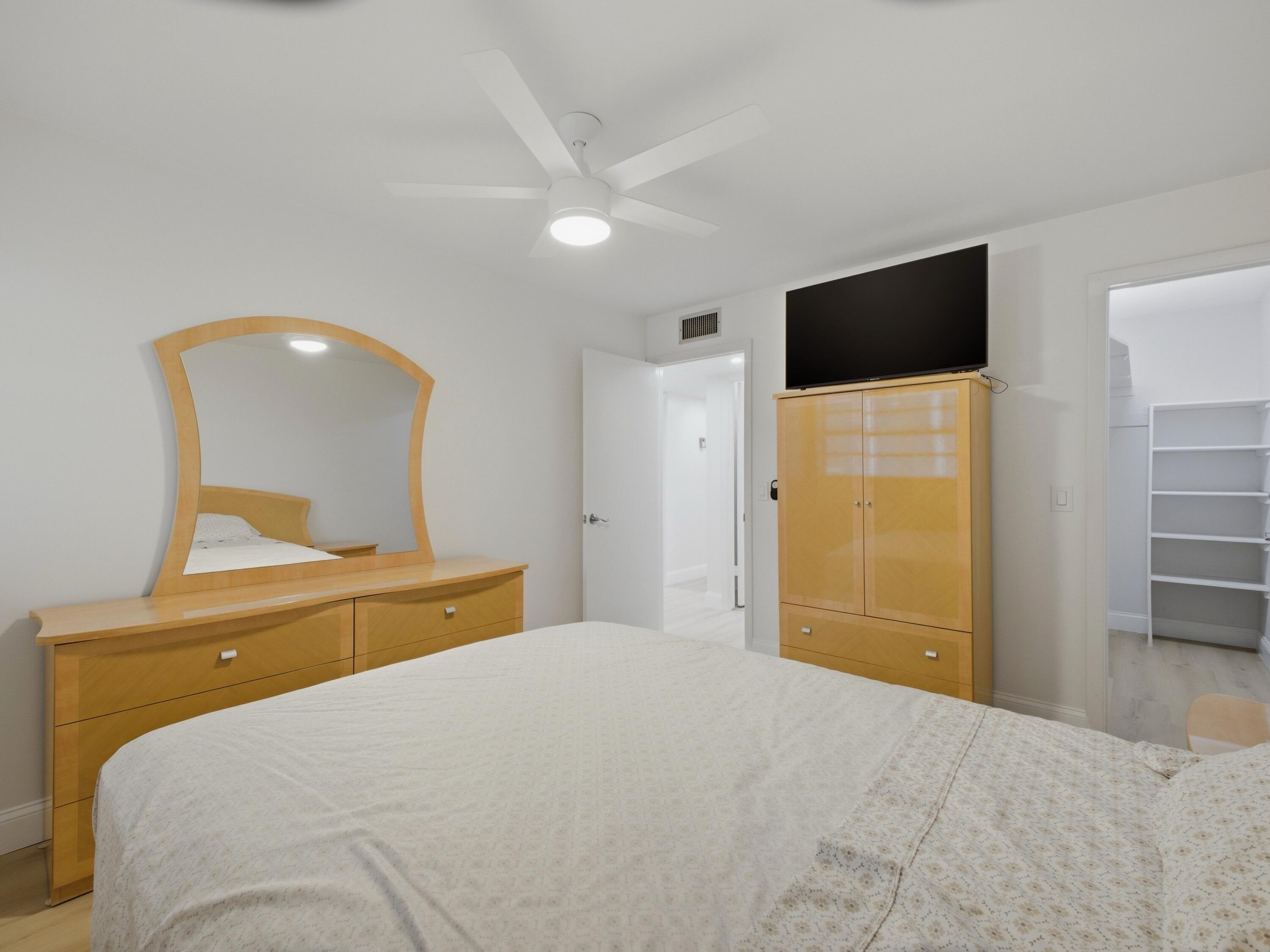 699 Flanders O Delray Beach, FL 33484 - Photo 17 of 39 a bedroom with a bed and a flat screen tv