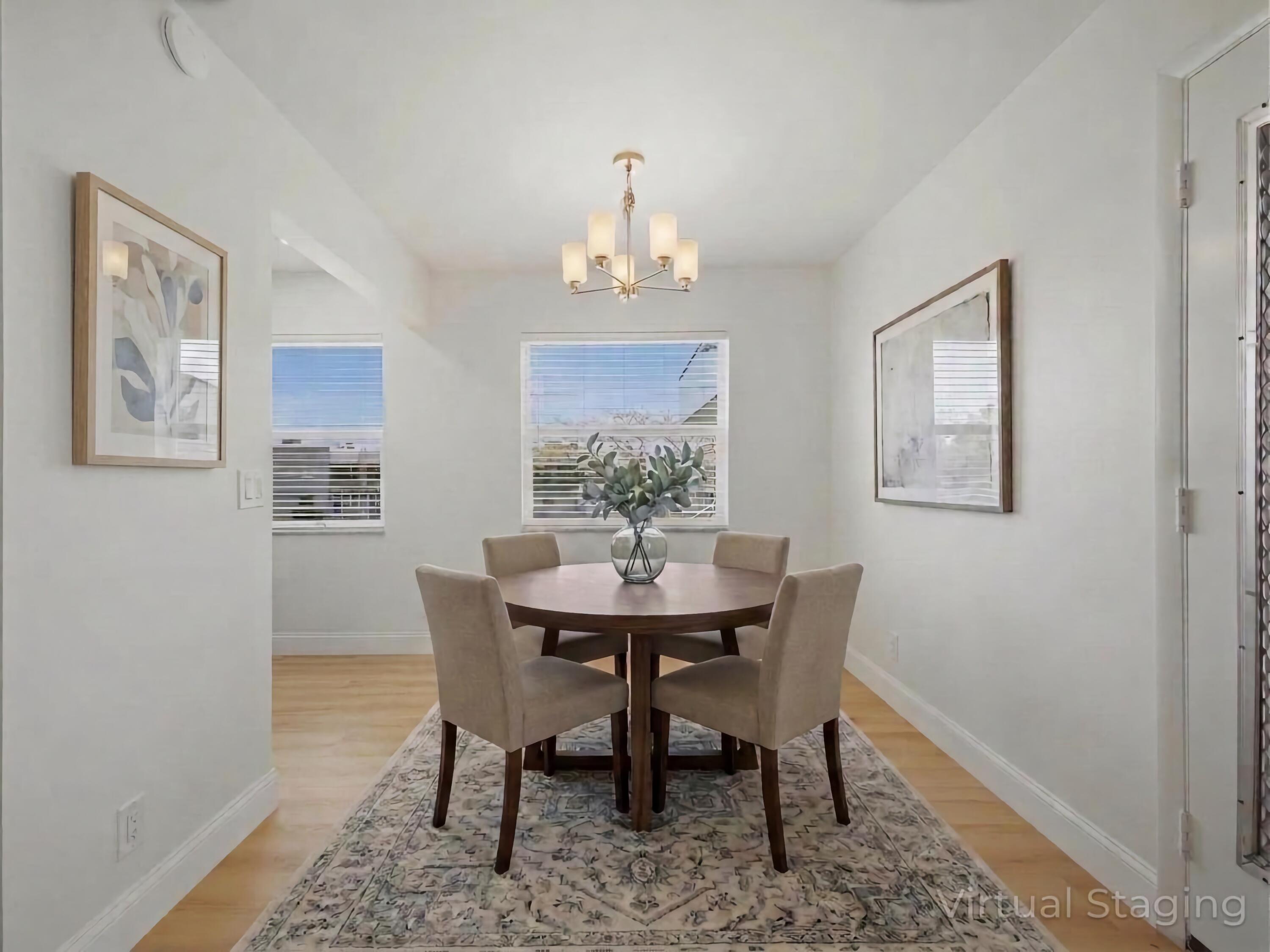 699 Flanders O Delray Beach, FL 33484 - Photo 5 of 39 a view of a dining room with furniture wooden floor and a chandelier