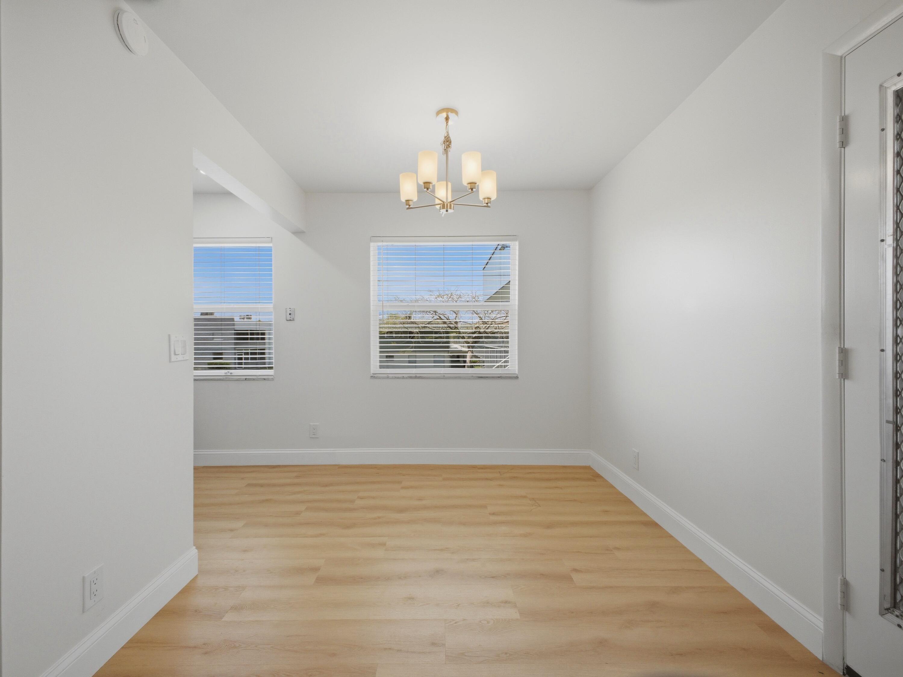 699 Flanders O Delray Beach, FL 33484 - Photo 7 of 39 a view of an empty room with wooden floor