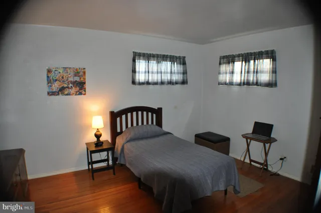 a balcony with chairs and wooden floor