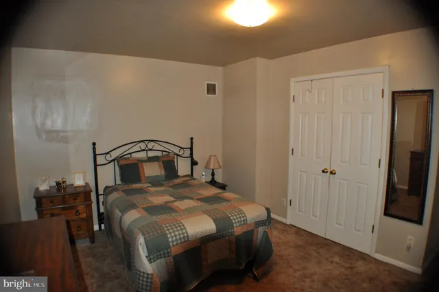 a bedroom with a bed and a mirror