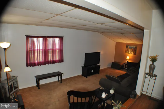 a livingroom with workspace and a couch