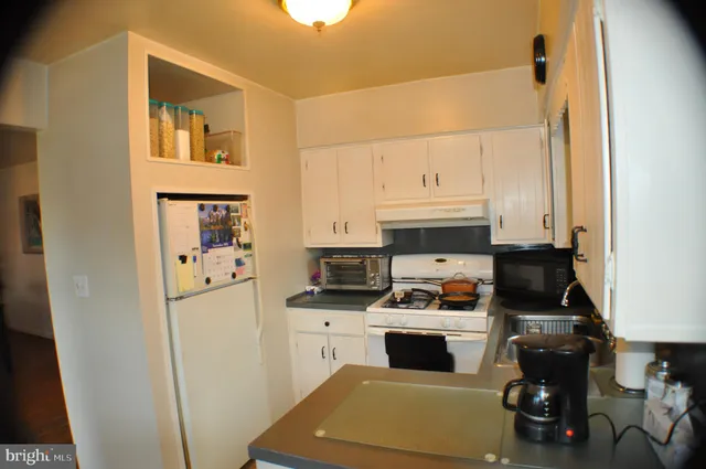 a kitchen with stainless steel appliances a stove a microwave and a refrigerator