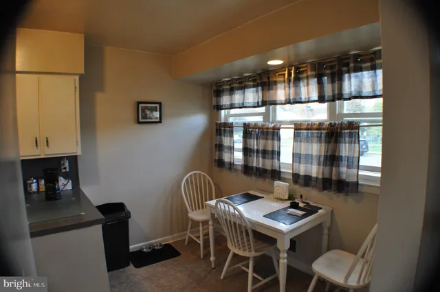 a room with furniture a lamp and large window