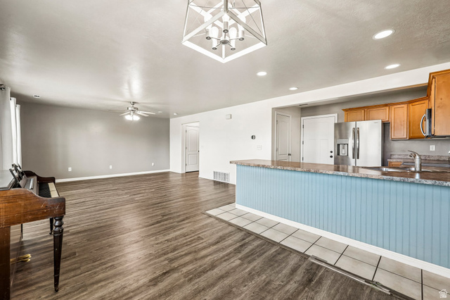 3215 West 450 North West Point, UT 84015 - Photo 9 of 40 Open-concept living space featuring wood-finish flooring and a ceiling fan