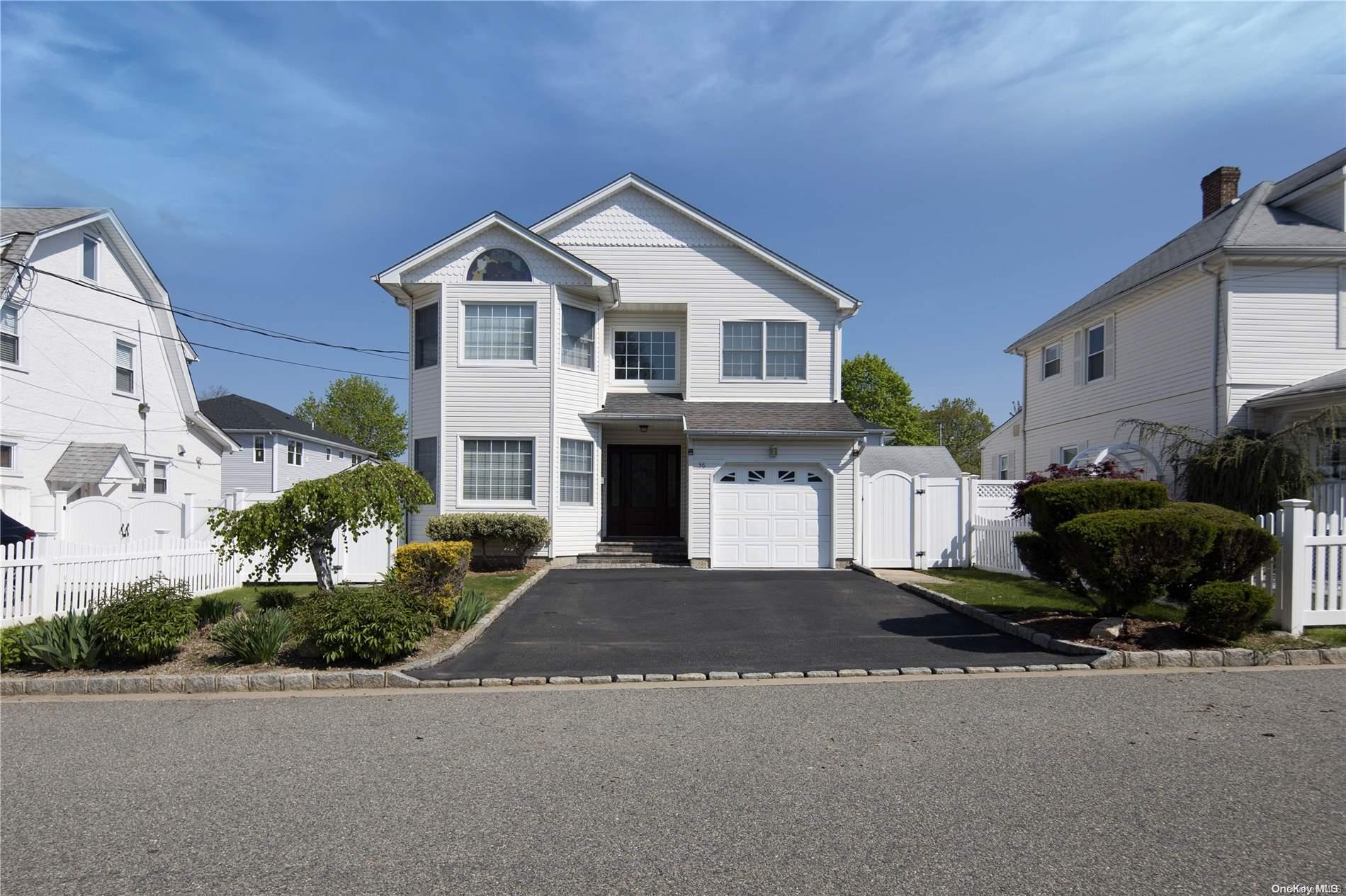 36 Whitney Avenue Syosset, NY 11791 - Photo 1 of 1 a front view of a house with a yard and garage