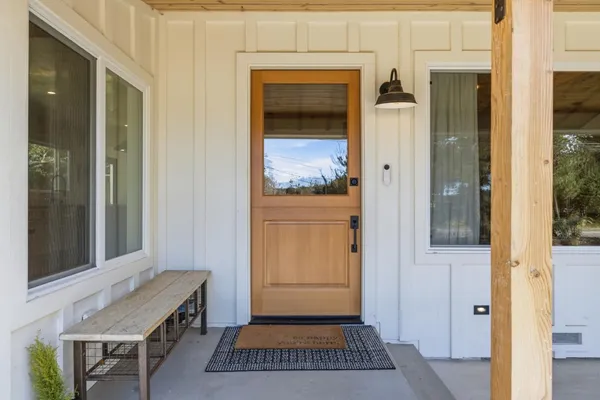 a view of a hallway with a door and a bedroom