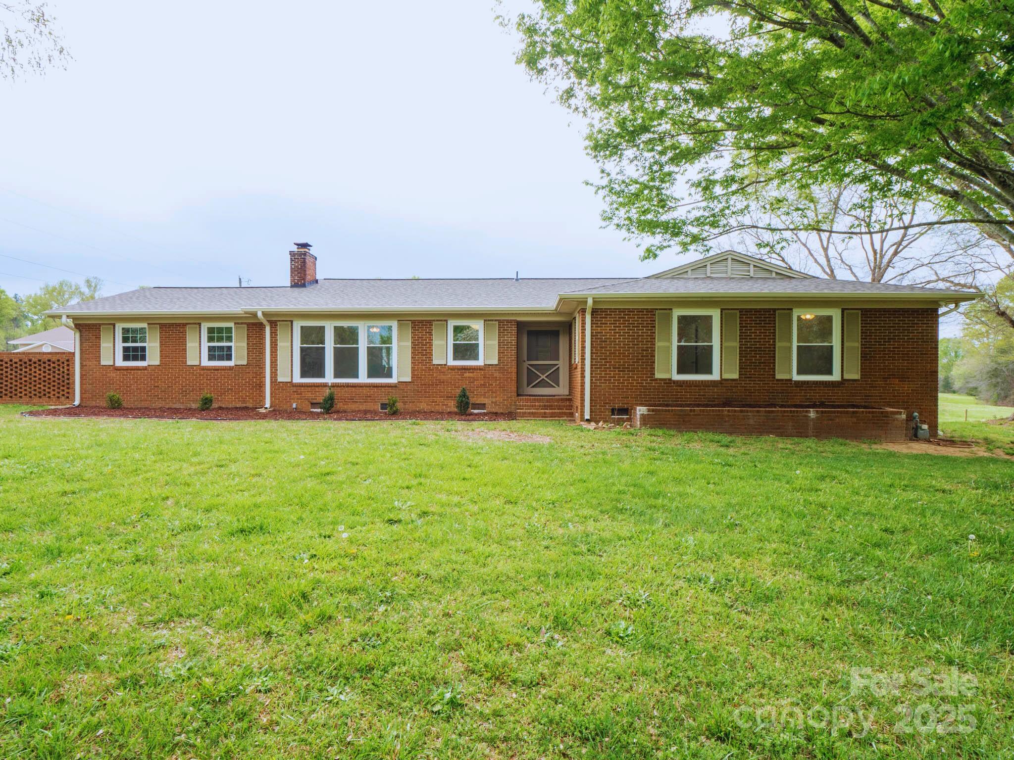 a front view of house with yard and green space