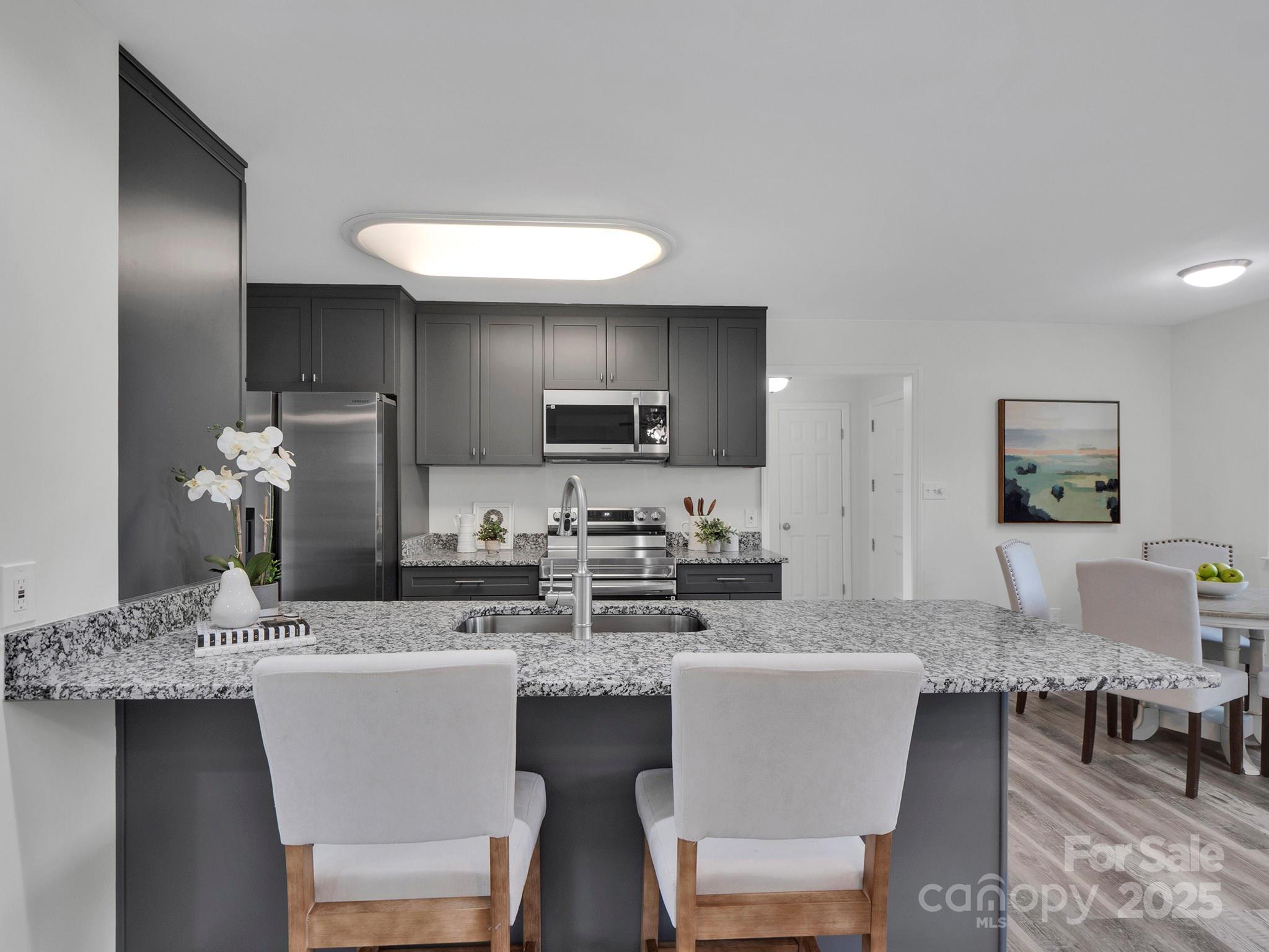 3452 Flat Creek Road Lancaster, SC 29720 - Photo 5 of 34 a kitchen with a dining table chairs and microwave