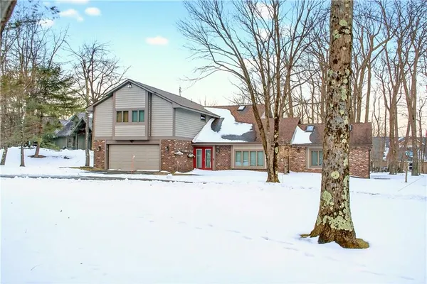 a view of a house with snow on the road