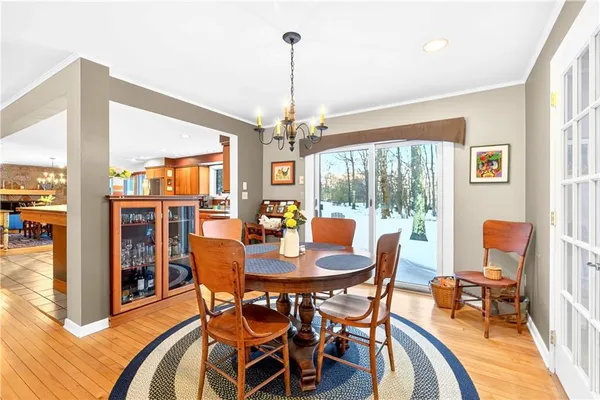 a view of a dining room with furniture large windows and wooden floor