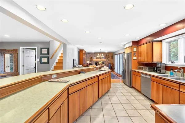 a large kitchen with stainless steel appliances granite countertop a large counter top and a stove