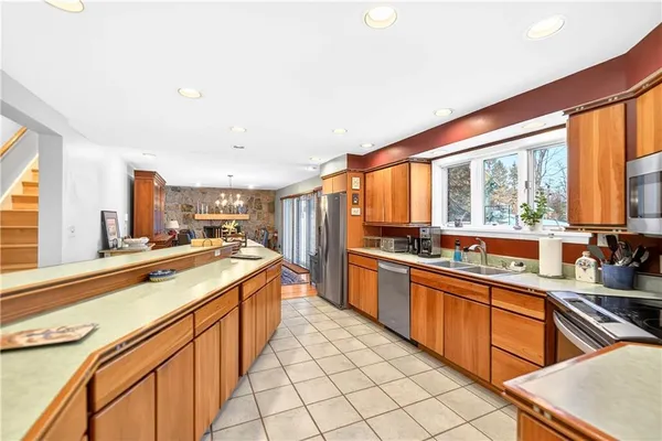 a large kitchen with stainless steel appliances granite countertop a sink and cabinets