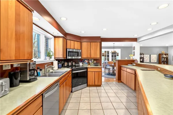 a kitchen with stainless steel appliances granite countertop sink stove and refrigerator