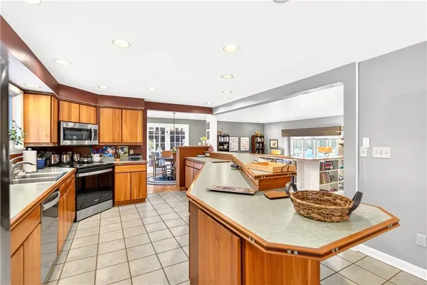 a kitchen with stainless steel appliances granite countertop a stove and a sink