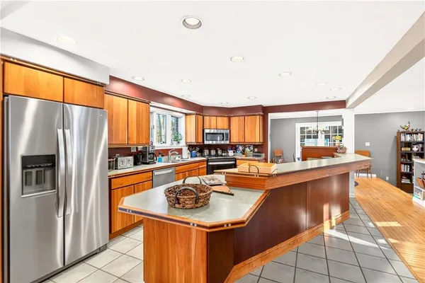 a kitchen with stainless steel appliances granite countertop a sink a stove and refrigerator