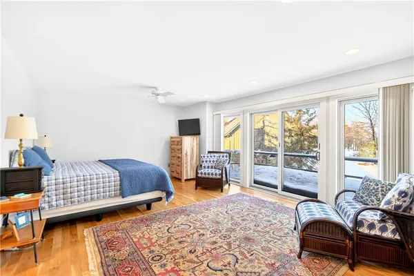 a bedroom with furniture and a large window
