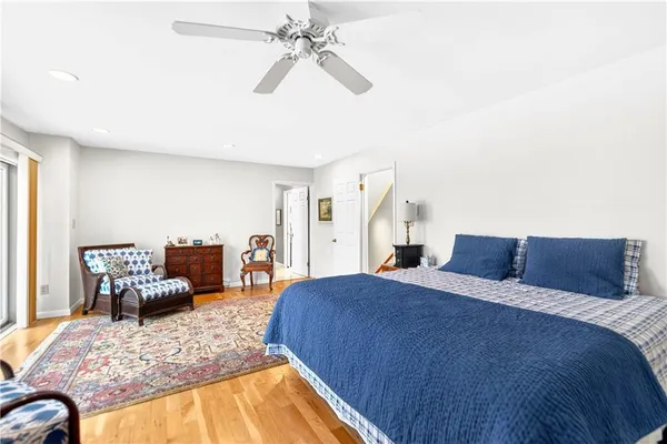a bedroom with a bed couch and a window