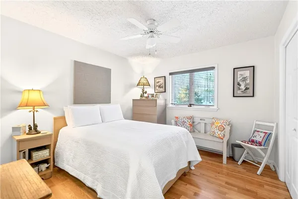 a bedroom with a bed and a table in it with window